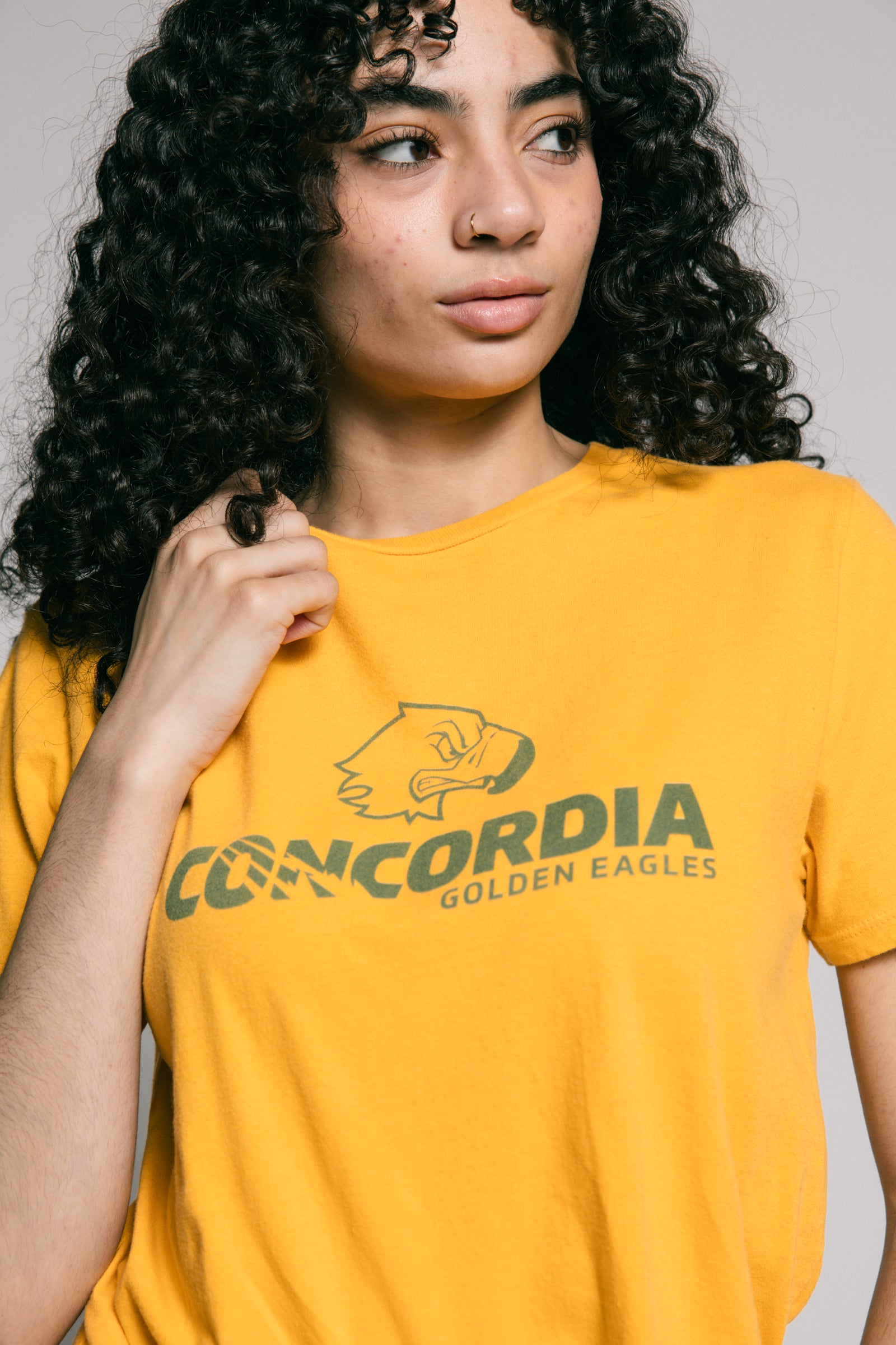 Person wearing a yellow t-shirt with 'Concordia Golden Eagles' logo